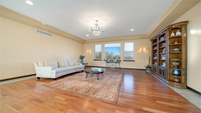 living room featuring hardwood / wood-style floors and a notable chandelier