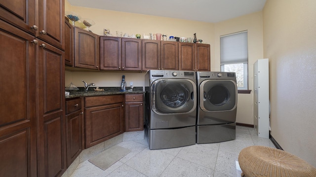 laundry area featuring cabinets, sink, and washing machine and clothes dryer