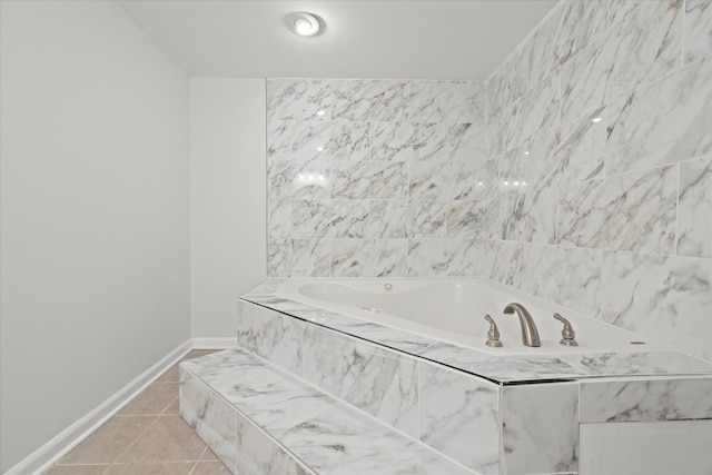 bathroom with tiled bath and tile patterned floors