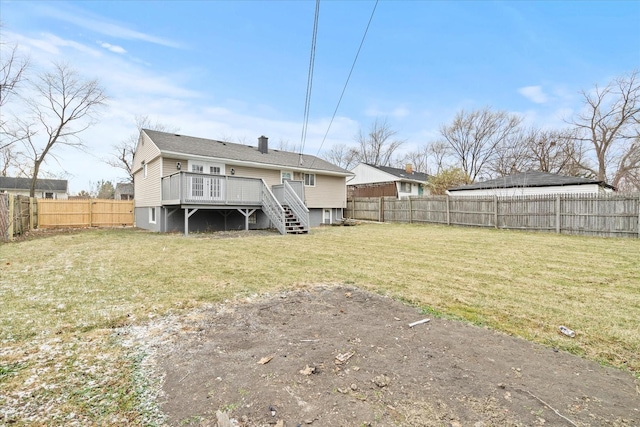 rear view of property featuring a deck and a yard