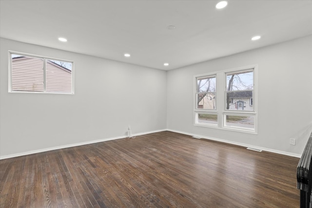 spare room with dark hardwood / wood-style floors