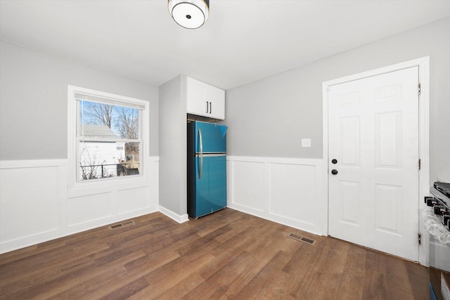 entryway with dark hardwood / wood-style flooring