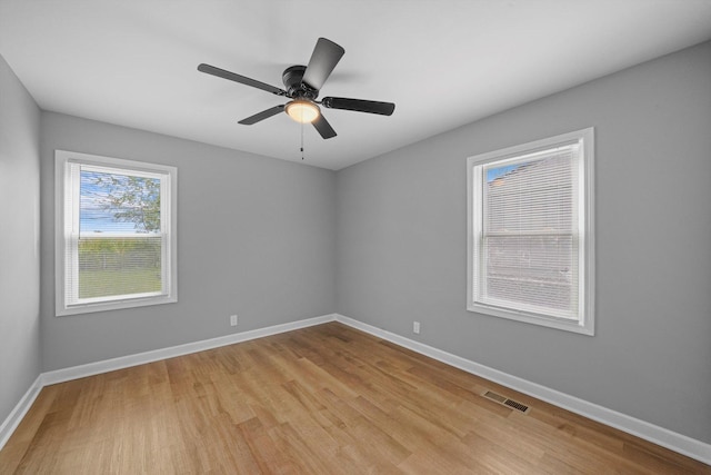 empty room featuring ceiling fan and light hardwood / wood-style floors