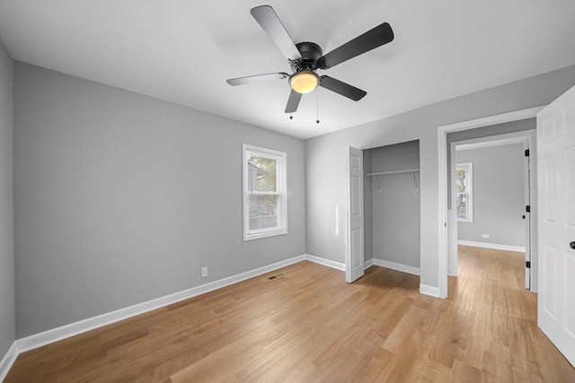 unfurnished bedroom with ceiling fan, a closet, and light hardwood / wood-style flooring