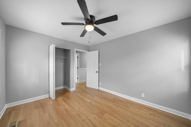 unfurnished bedroom with light hardwood / wood-style floors, a closet, and ceiling fan