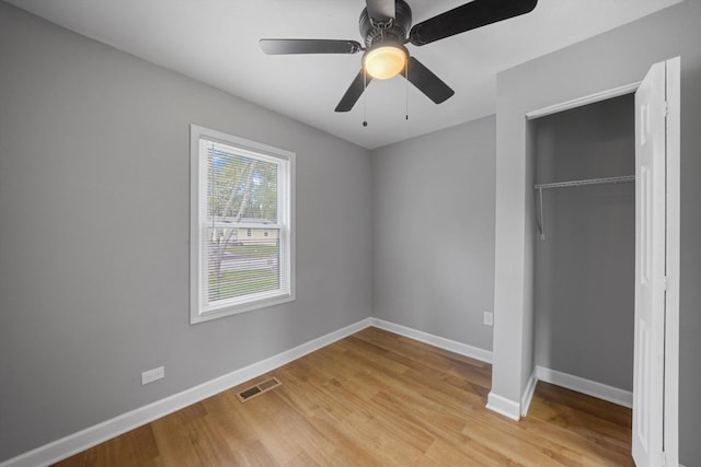 unfurnished bedroom with ceiling fan, a closet, and light hardwood / wood-style flooring