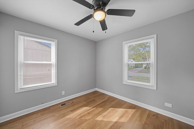 unfurnished room with ceiling fan and light wood-type flooring