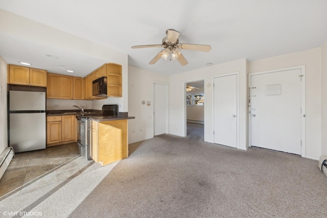 kitchen with light carpet, ceiling fan, and stainless steel appliances