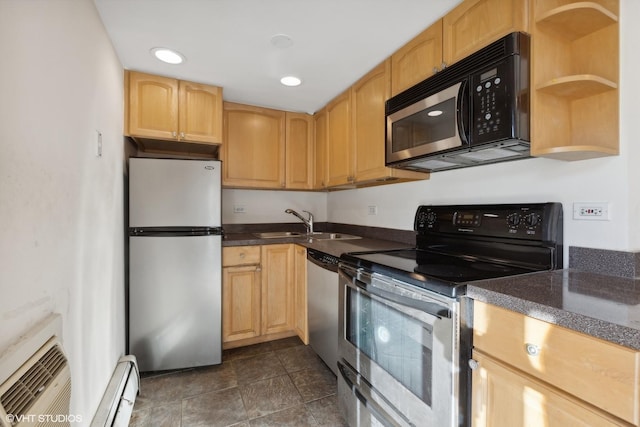 kitchen with baseboard heating, appliances with stainless steel finishes, light brown cabinetry, sink, and a wall unit AC