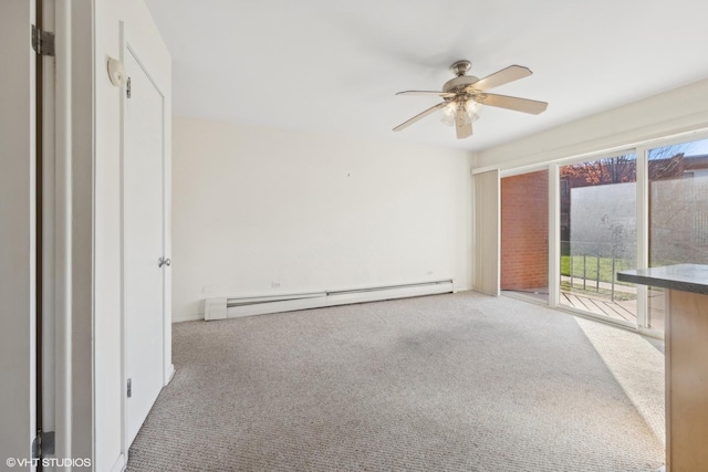 unfurnished room with baseboard heating, carpet flooring, a healthy amount of sunlight, and ceiling fan