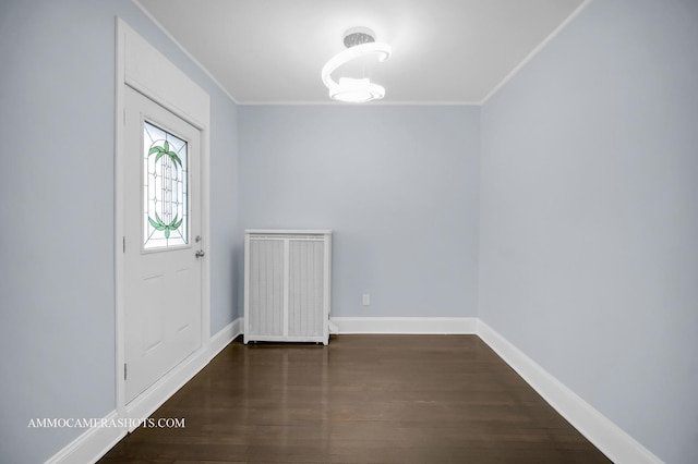 foyer with dark hardwood / wood-style floors and ornamental molding