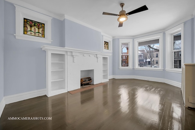 unfurnished living room with ceiling fan, dark hardwood / wood-style flooring, ornamental molding, and built in shelves