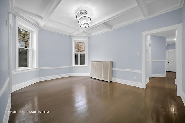 spare room featuring dark hardwood / wood-style flooring, beamed ceiling, and coffered ceiling