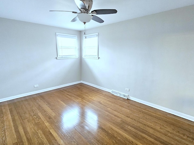 spare room with ceiling fan and wood-type flooring