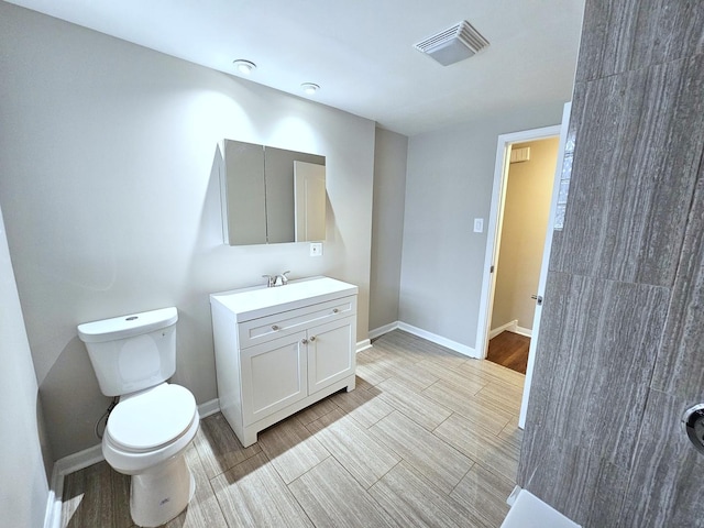 bathroom featuring toilet and vanity