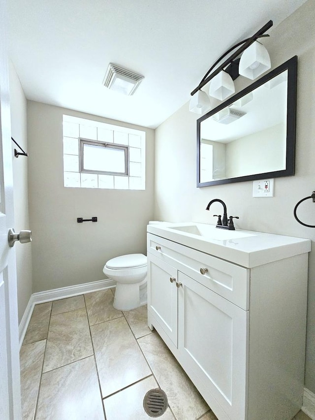 bathroom with toilet and vanity