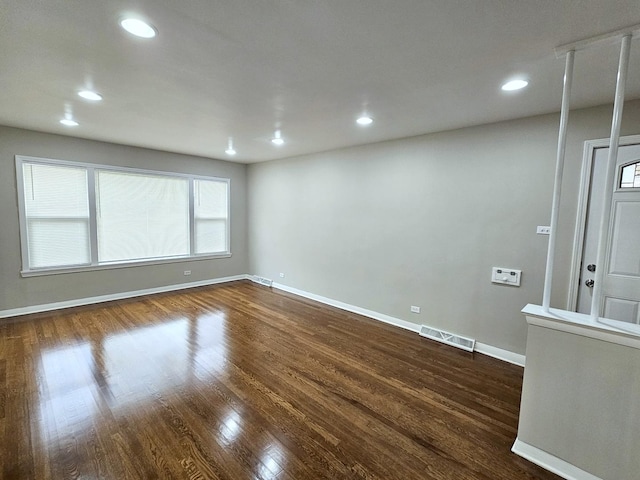 spare room with dark hardwood / wood-style floors