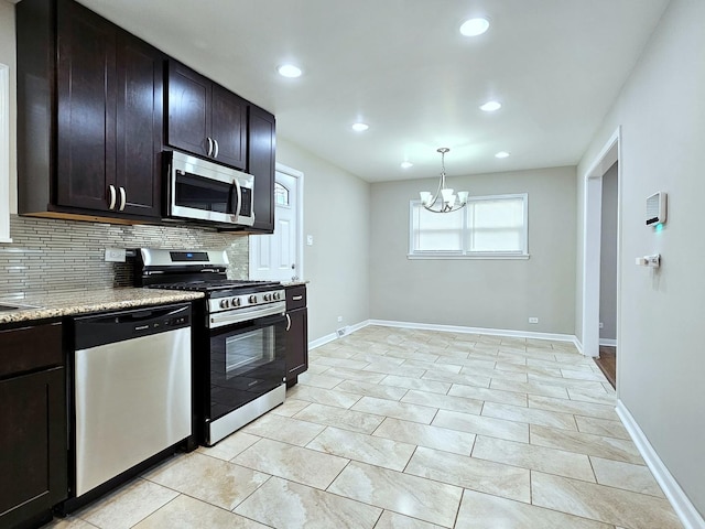 kitchen with decorative backsplash, appliances with stainless steel finishes, dark brown cabinets, and a notable chandelier