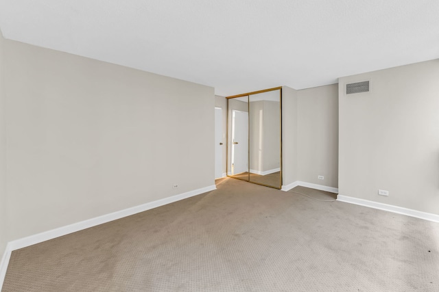 unfurnished bedroom with a closet and carpet flooring
