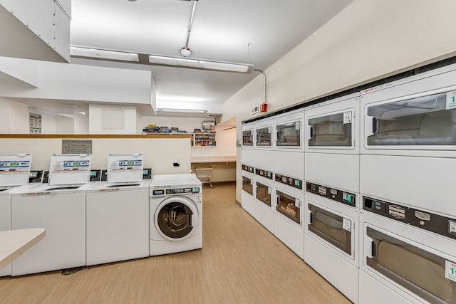 laundry area featuring stacked washer and clothes dryer, light hardwood / wood-style flooring, and washing machine and clothes dryer
