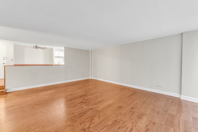 unfurnished room with ceiling fan and light hardwood / wood-style flooring