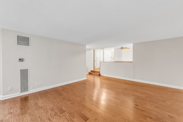 unfurnished living room featuring ceiling fan and light wood-type flooring