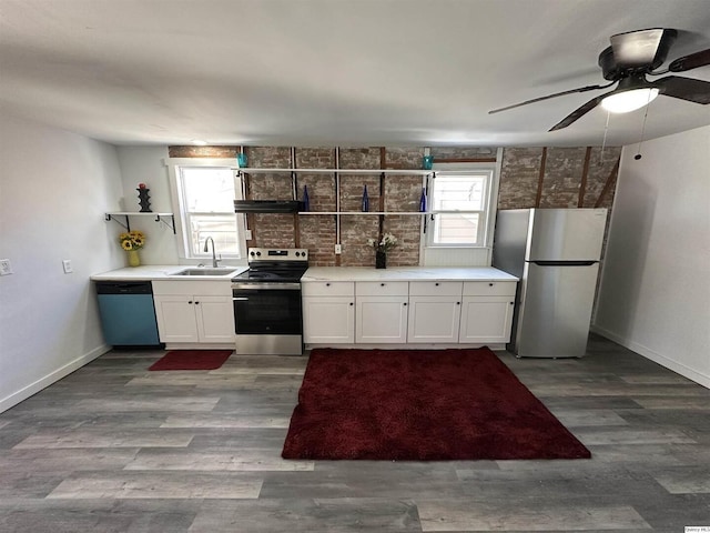 kitchen with sink, ceiling fan, stainless steel appliances, wood-type flooring, and white cabinets