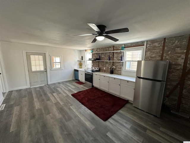 kitchen featuring sink, appliances with stainless steel finishes, dark hardwood / wood-style flooring, ceiling fan, and white cabinets