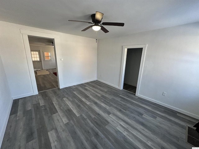 unfurnished room with dark hardwood / wood-style floors and ceiling fan