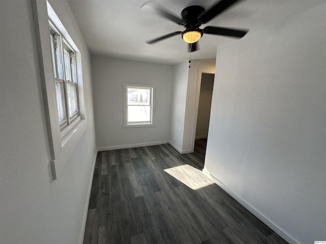 unfurnished room with dark hardwood / wood-style floors and ceiling fan