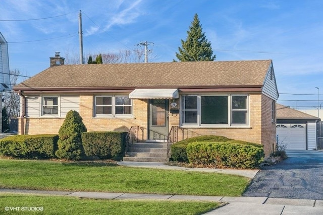 view of front of property featuring a garage and a front lawn