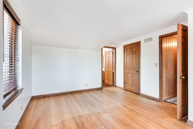 unfurnished bedroom with light hardwood / wood-style flooring and crown molding