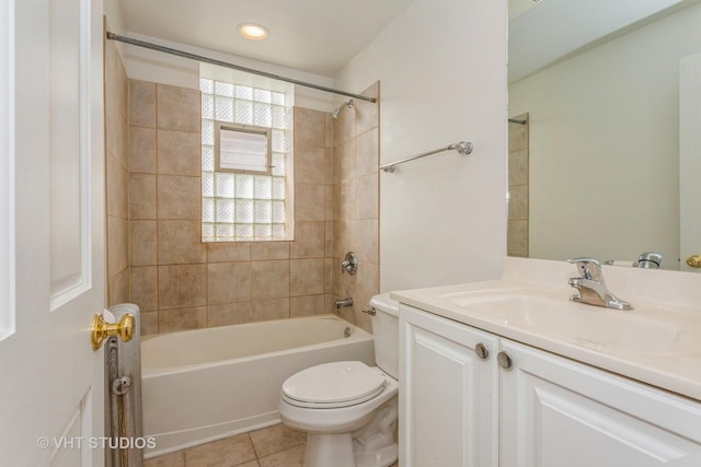 full bathroom with toilet, tile patterned floors, tiled shower / bath, and vanity