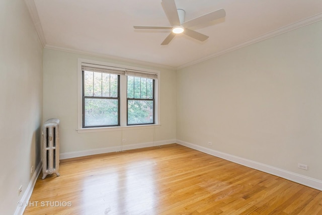 unfurnished room featuring ceiling fan, radiator heating unit, ornamental molding, and light hardwood / wood-style floors