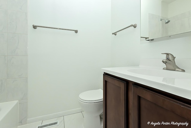 full bathroom featuring toilet, tile patterned flooring, tiled shower / bath, and vanity