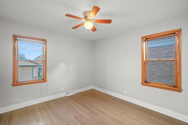 empty room featuring wood-type flooring and ceiling fan