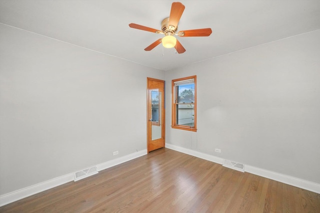 empty room featuring hardwood / wood-style flooring and ceiling fan