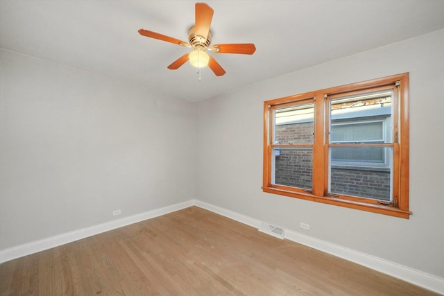 empty room with ceiling fan and light wood-type flooring