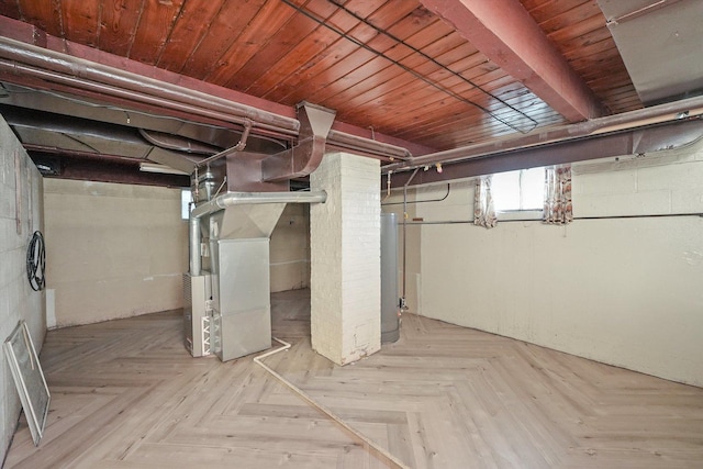 basement featuring heating unit, light parquet flooring, and water heater