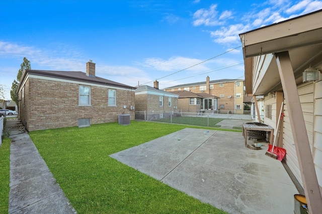 view of yard with cooling unit and a patio