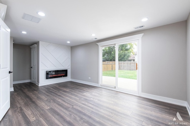 unfurnished living room featuring dark hardwood / wood-style floors and a fireplace