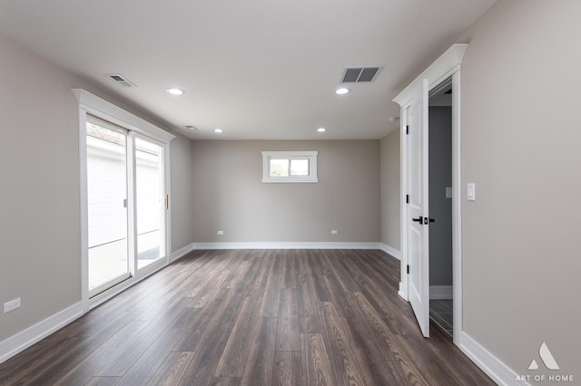 spare room featuring dark hardwood / wood-style flooring