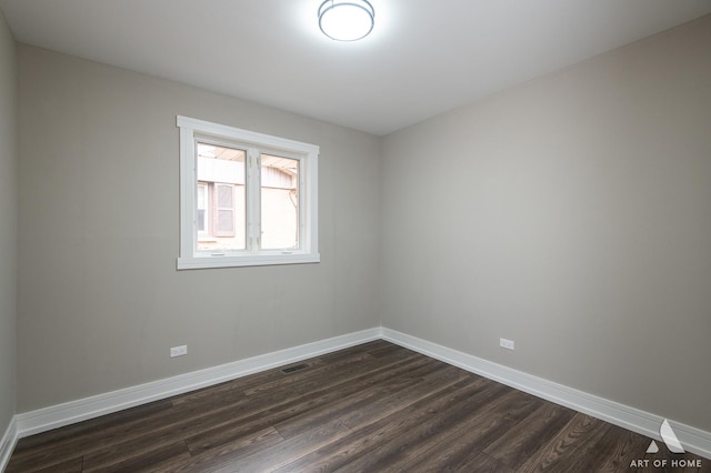 spare room featuring dark wood-type flooring