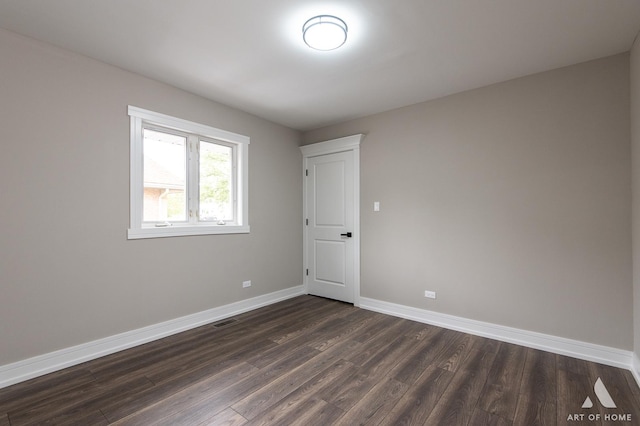 empty room with dark hardwood / wood-style floors