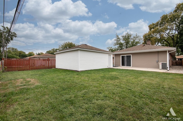 rear view of house with central AC unit, a patio area, and a yard