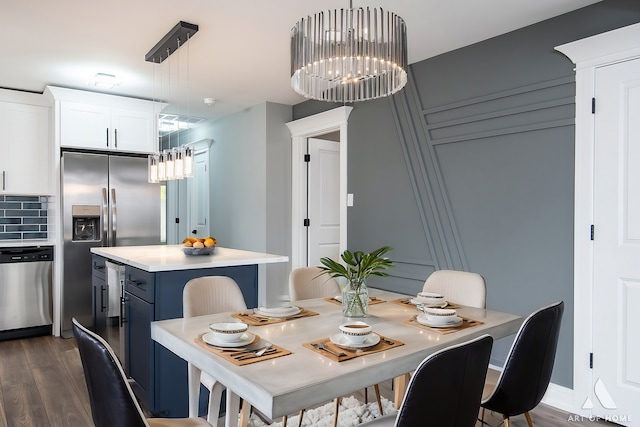 dining room featuring dark wood-type flooring and a chandelier