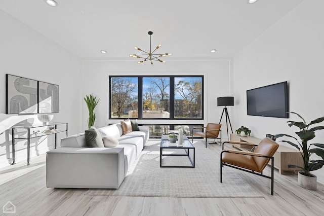 living room featuring light hardwood / wood-style flooring and a notable chandelier