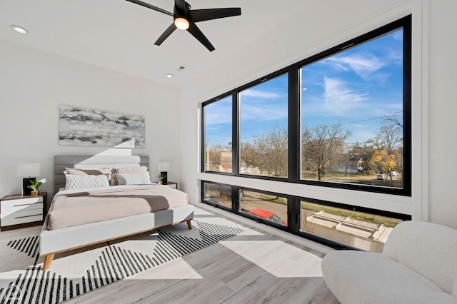 bedroom with ceiling fan and wood-type flooring