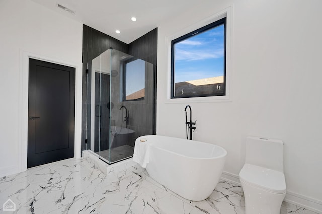 bathroom featuring toilet and separate shower and tub