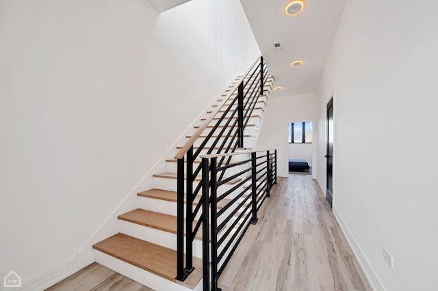 stairs with hardwood / wood-style flooring